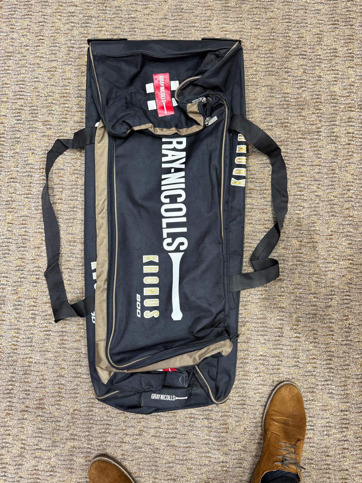 Black sports bag with 'Gray-Nicolls' branding on a textured surface.